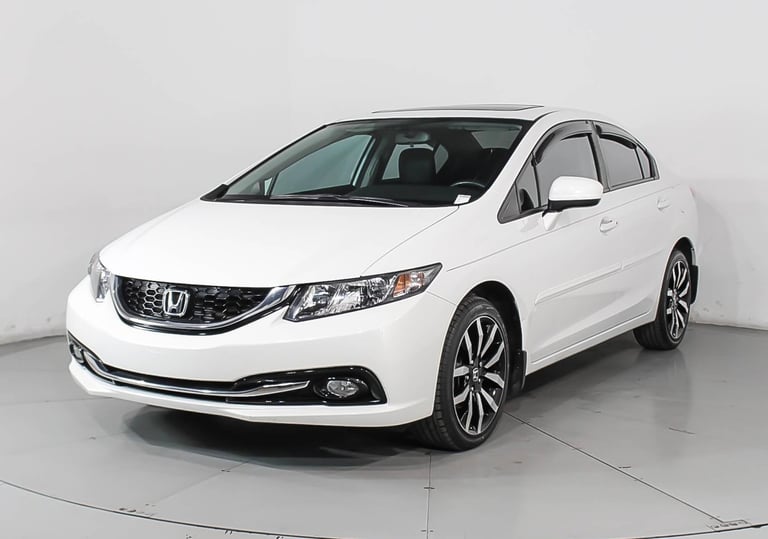 White Honda Civic sedan photographed from front-side angle in a studio setting against a gray background